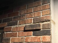 Outside bricks coming out of wall.