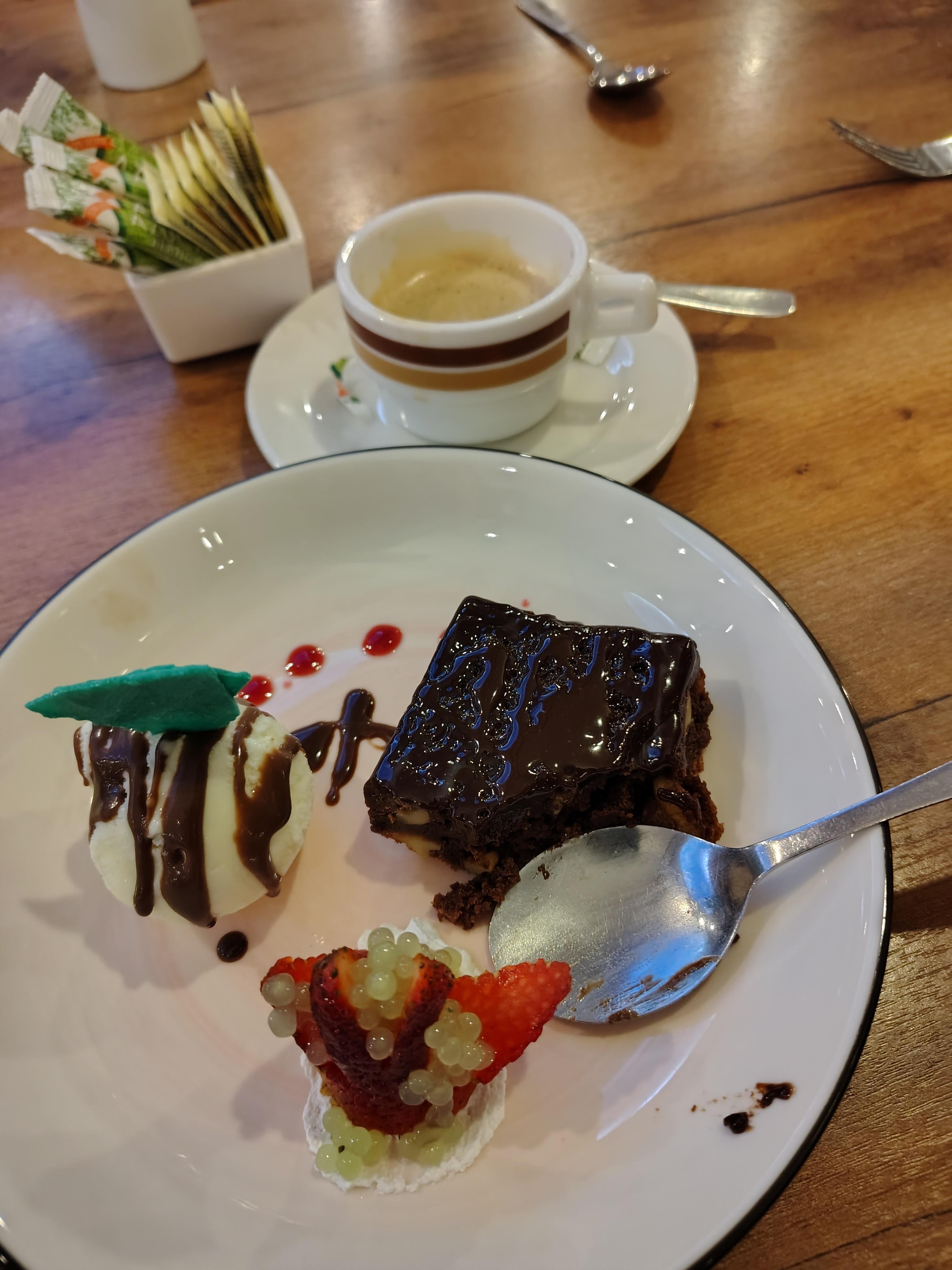 Brownie with ice cream and a strawberry for dessert.
