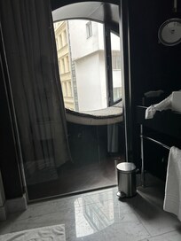 View from bathroom. Can see outside through glass wall.