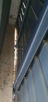 Pigeon debris behind patio shutters by bedroom door