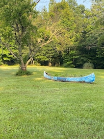 Love the canoe with flowers planted in it