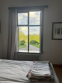 A relaxing room with a full sized bed and a set of bunk beds