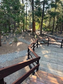 Stairs from porch down to swing overlooking creek