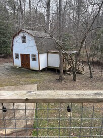 The space, although on 2 acres,â is basically adjacent. This is a photo from the back porch. No zoom. Only a driveway separating the two.
