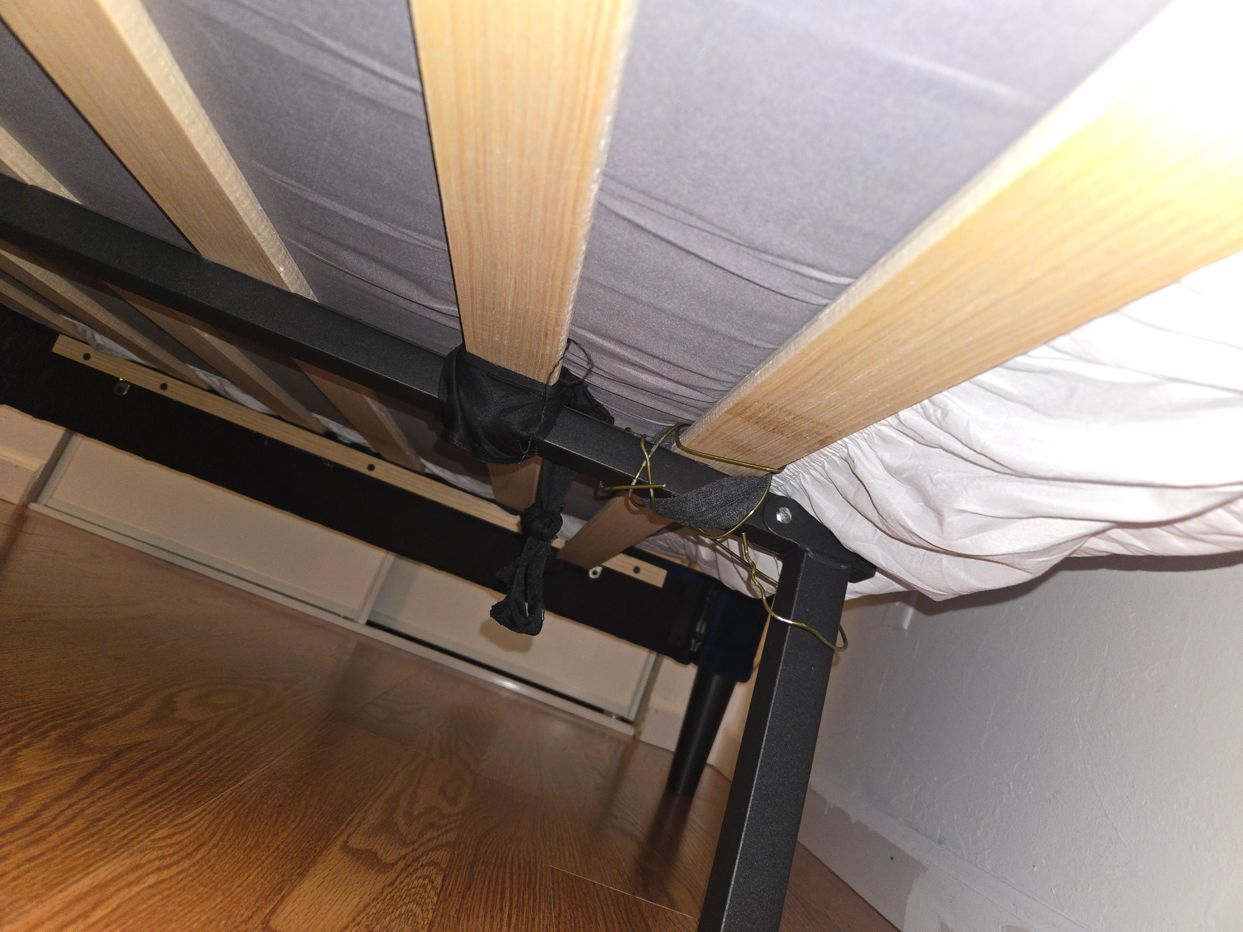 Broken bed help together with wire and a cloth strap.