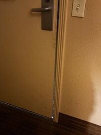 Room door with noticible gap.
