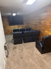 Theater room with seating for seven.