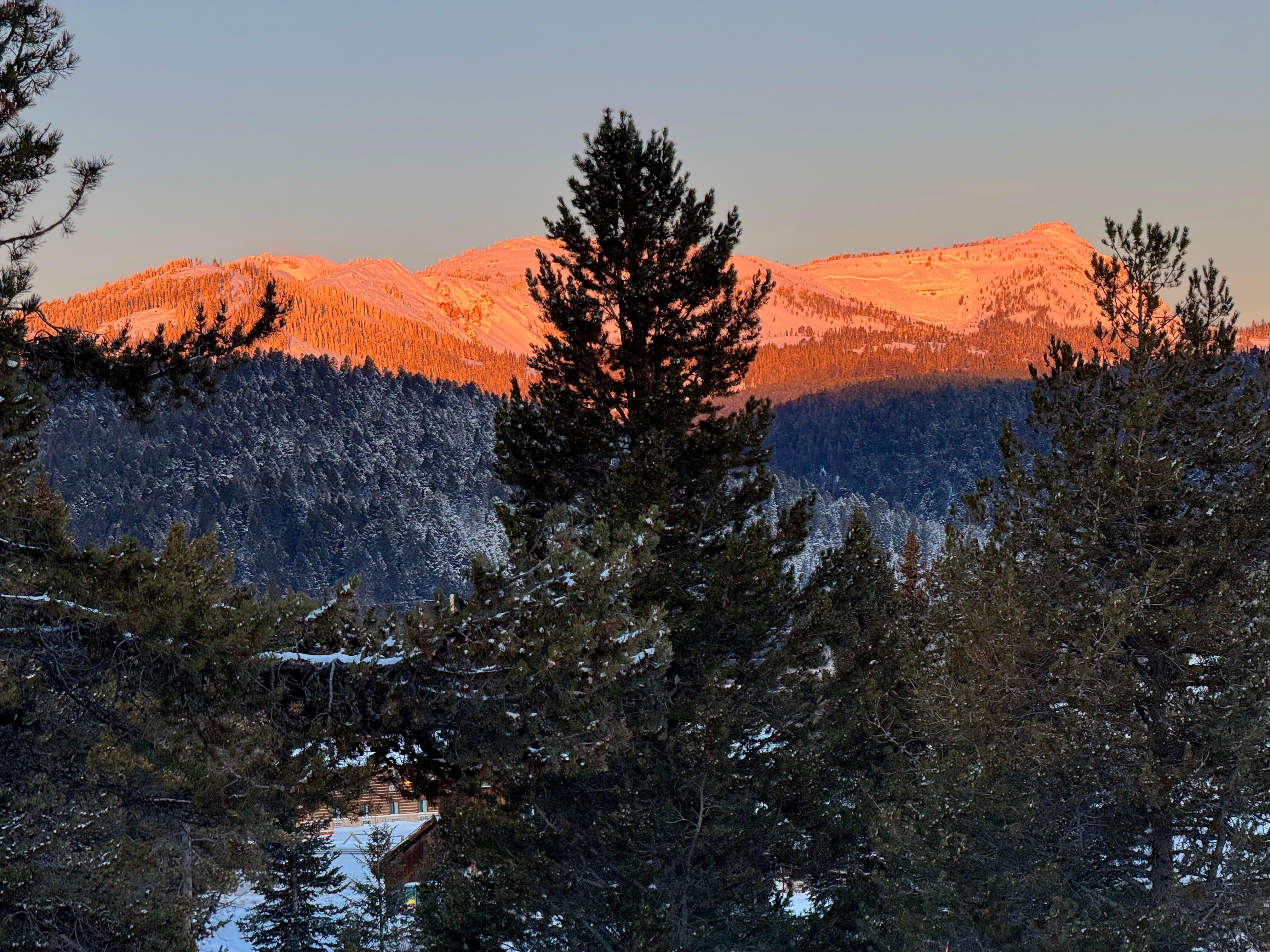 Alpenglow from morning sunrise on Lionhead Peak from the cabin front porch.