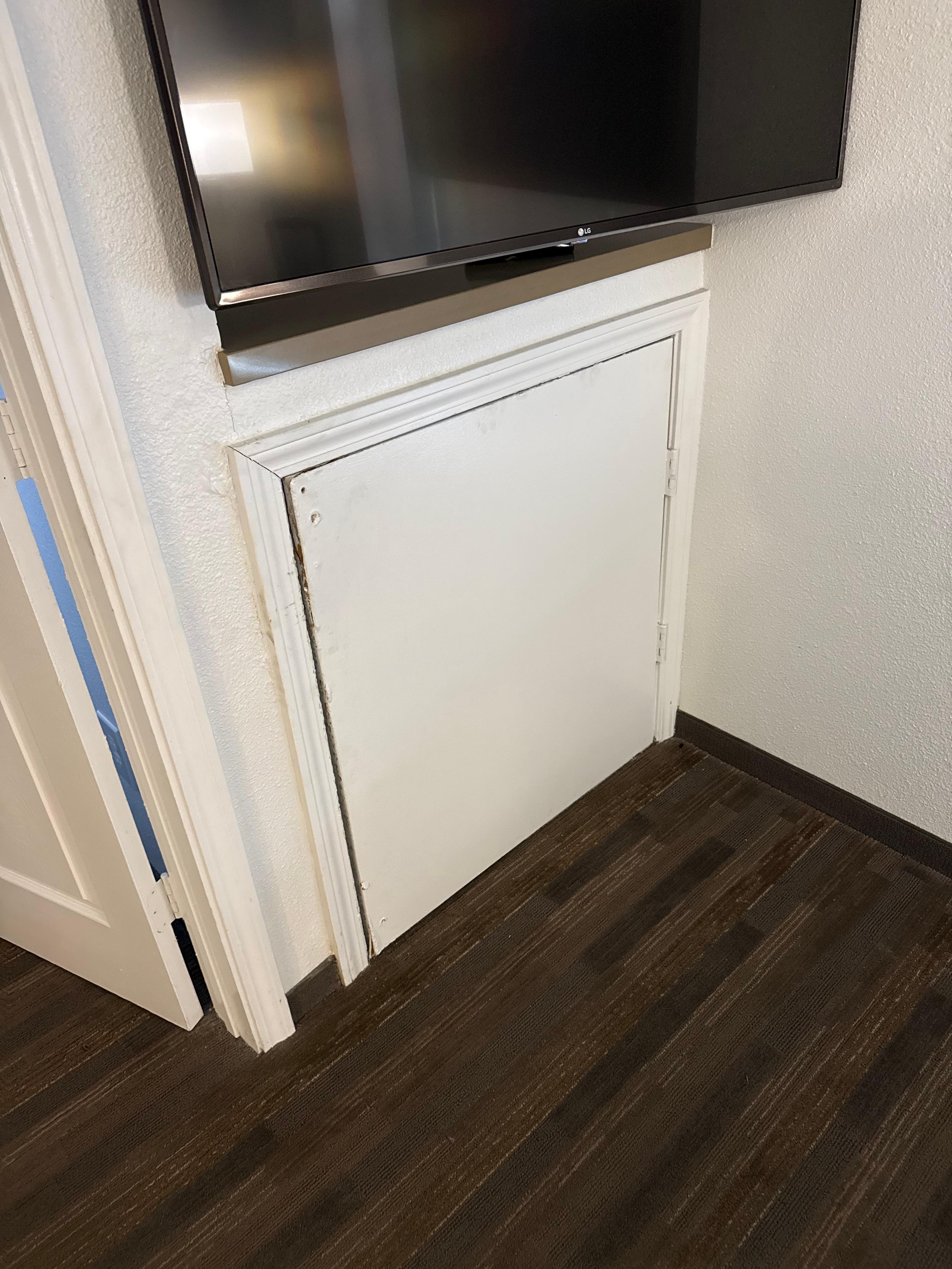 This wall panel was peeling off the wall underneath the TV. Notice the stains all over the place. 