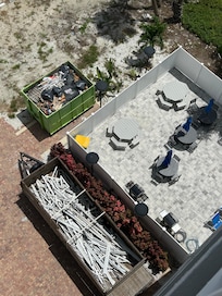 Dumpster just on the other side of pool fence where workers threw old windows.