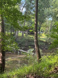 View of the cabin from the bridge over the creek