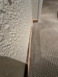 Skirting board hanging off.