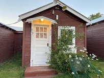 The cabin was maybe ten by fifteen. Old building with old furniture and linens.