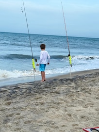 Grandson checking the fishing poles.