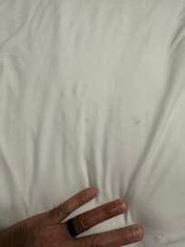 Stains and debris under the mattress.