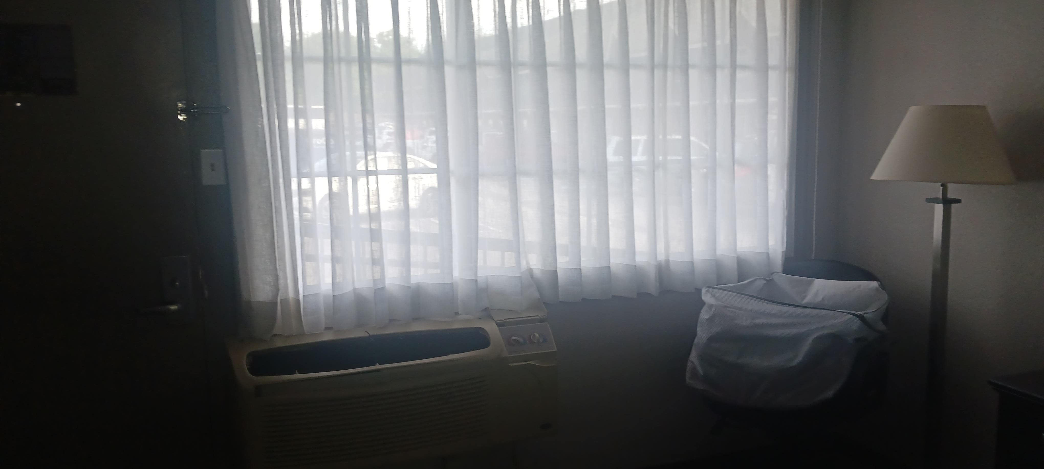Window facing the parking lot had only sheer curtains. No blinds or shades for privacy.