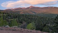 A lovely sunset coloring Pikes Peak pink, from the front porch.