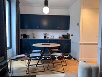 Kitchen has laundry (washer and dryer in one, but not great at drying). Also has a juicer! And a dishwasher, and a hidden fridge.