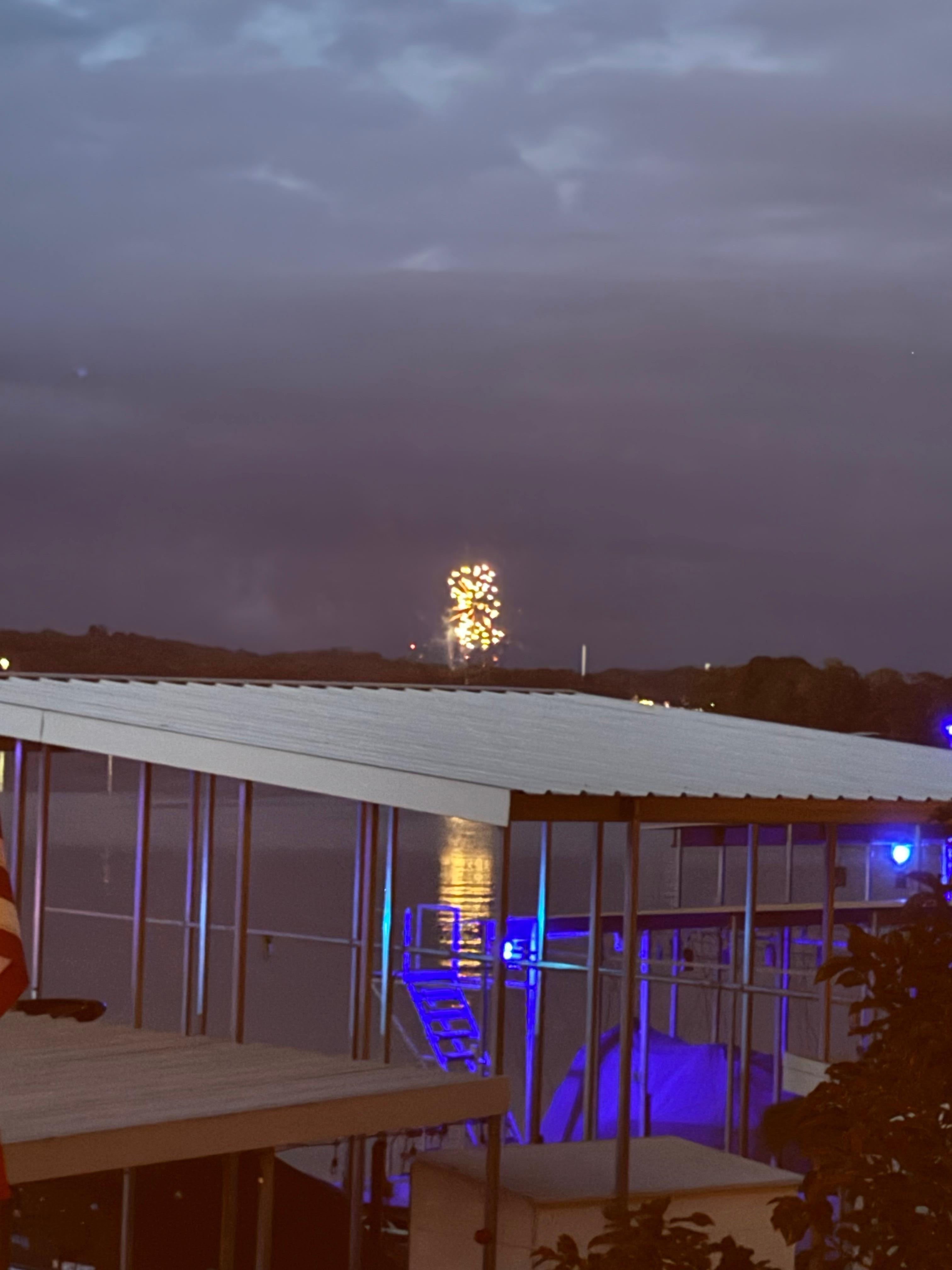 Fireworks at night watched from deck off the house