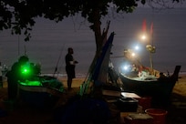 Fishing boats come in just before dawn.
