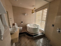 Clean wet room style bathroom. Unfortunately the bath was cracked, the view was not as described, and the shower was cold one morning.