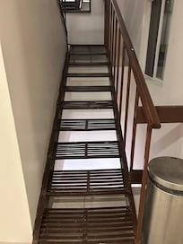 Very narrow metal staircase from second floor up