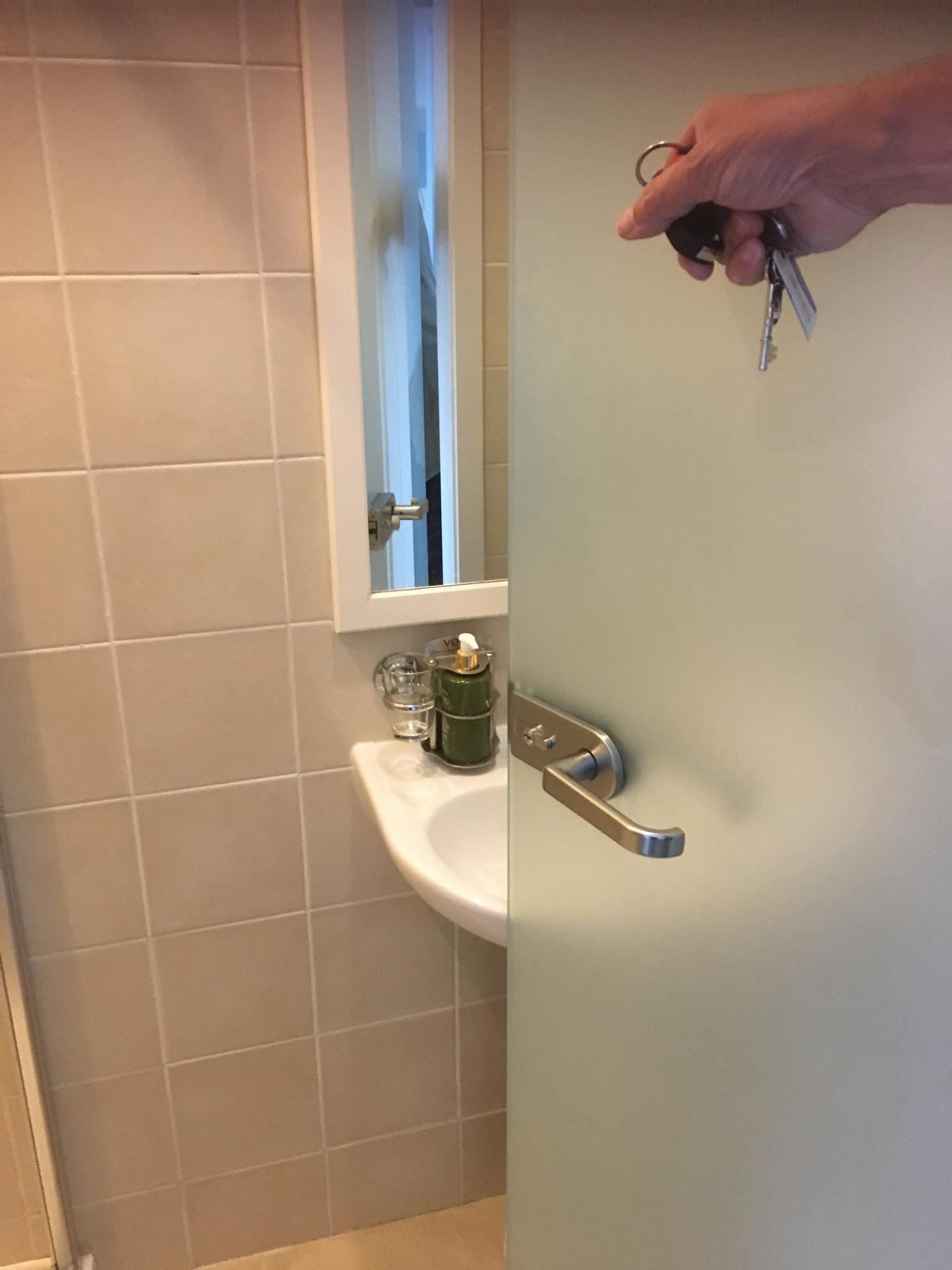 Frosted glass door to shower room hits basin when opened