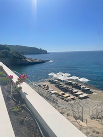 Private sunbathing on rock area with steps into sea