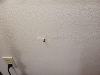 Protruding nail in wall
