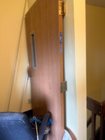 Stairwell door off the hinges, the reason for this door in a building is to help slow a fire if on breaks out