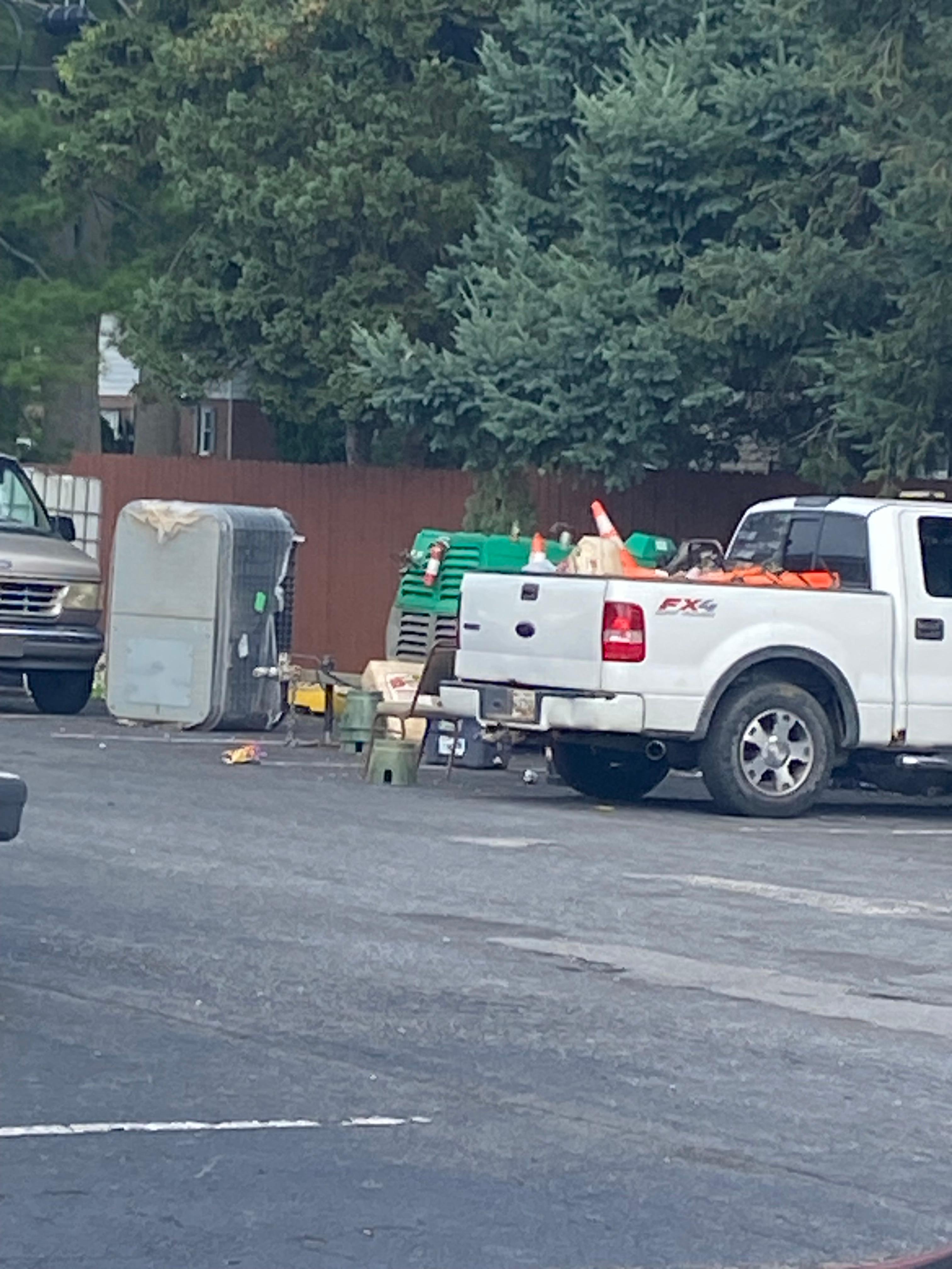 Chairs and debris in parking lot where construction guys party.