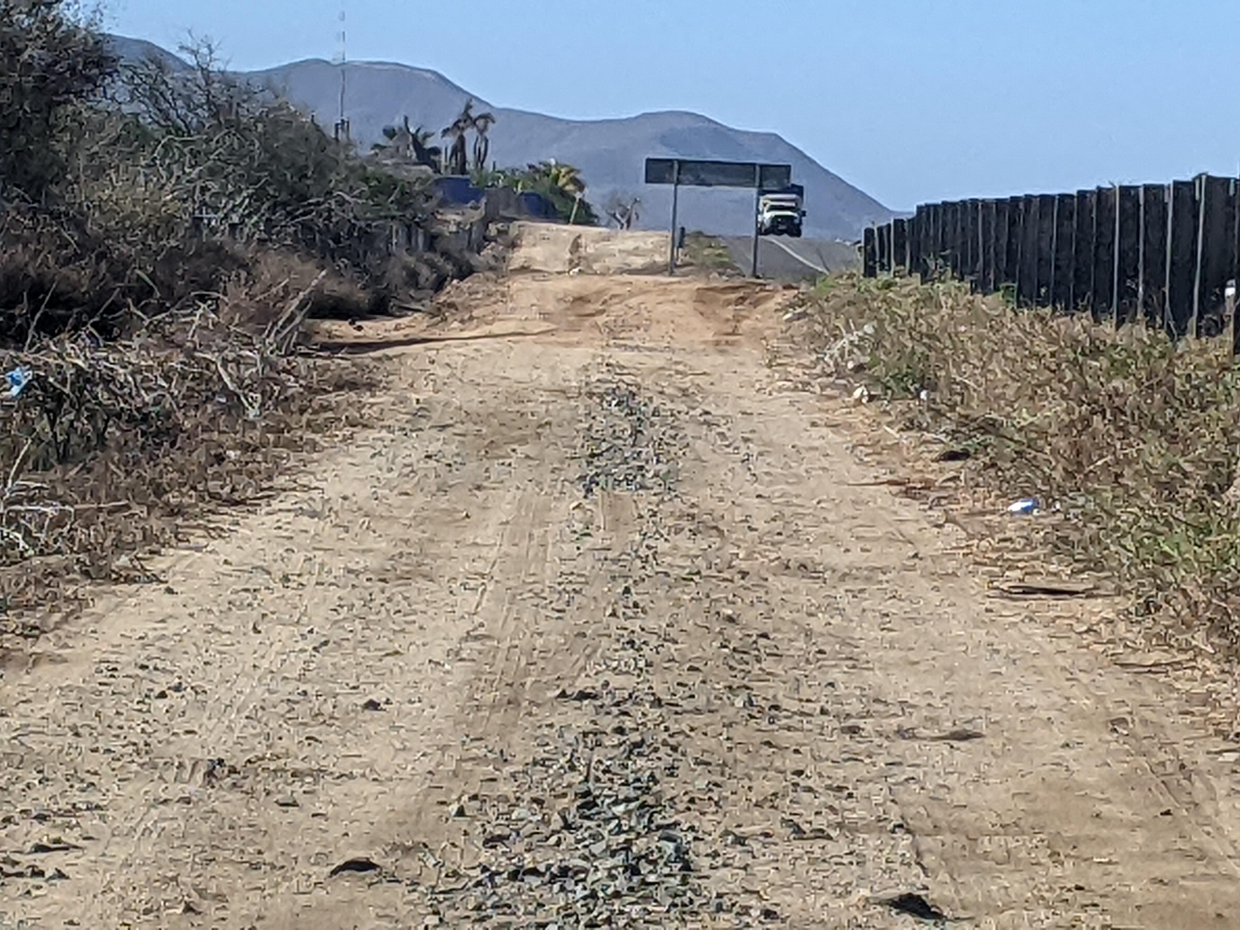 Dirt road access from highway, not a true exit