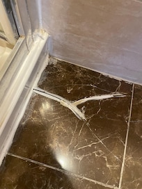 Cracked tiles with a poor attempt of repair.