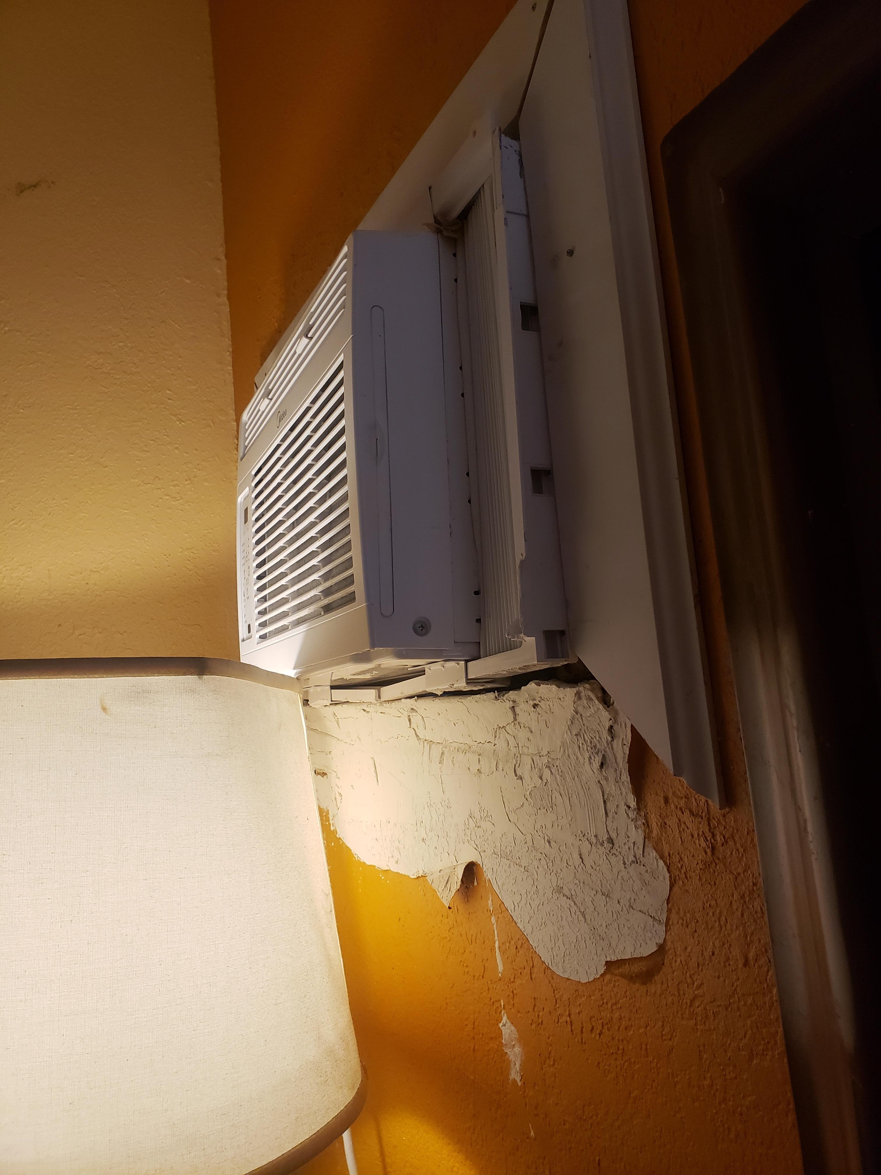 AC pushed inward and wall damage 