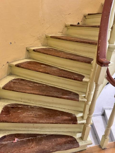 stairs to second floor ''suite" so old that they were worn out, uneven,  a real safety hazard