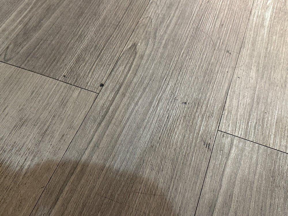 Filthy floor that looks like it's never been mopped or even swept.