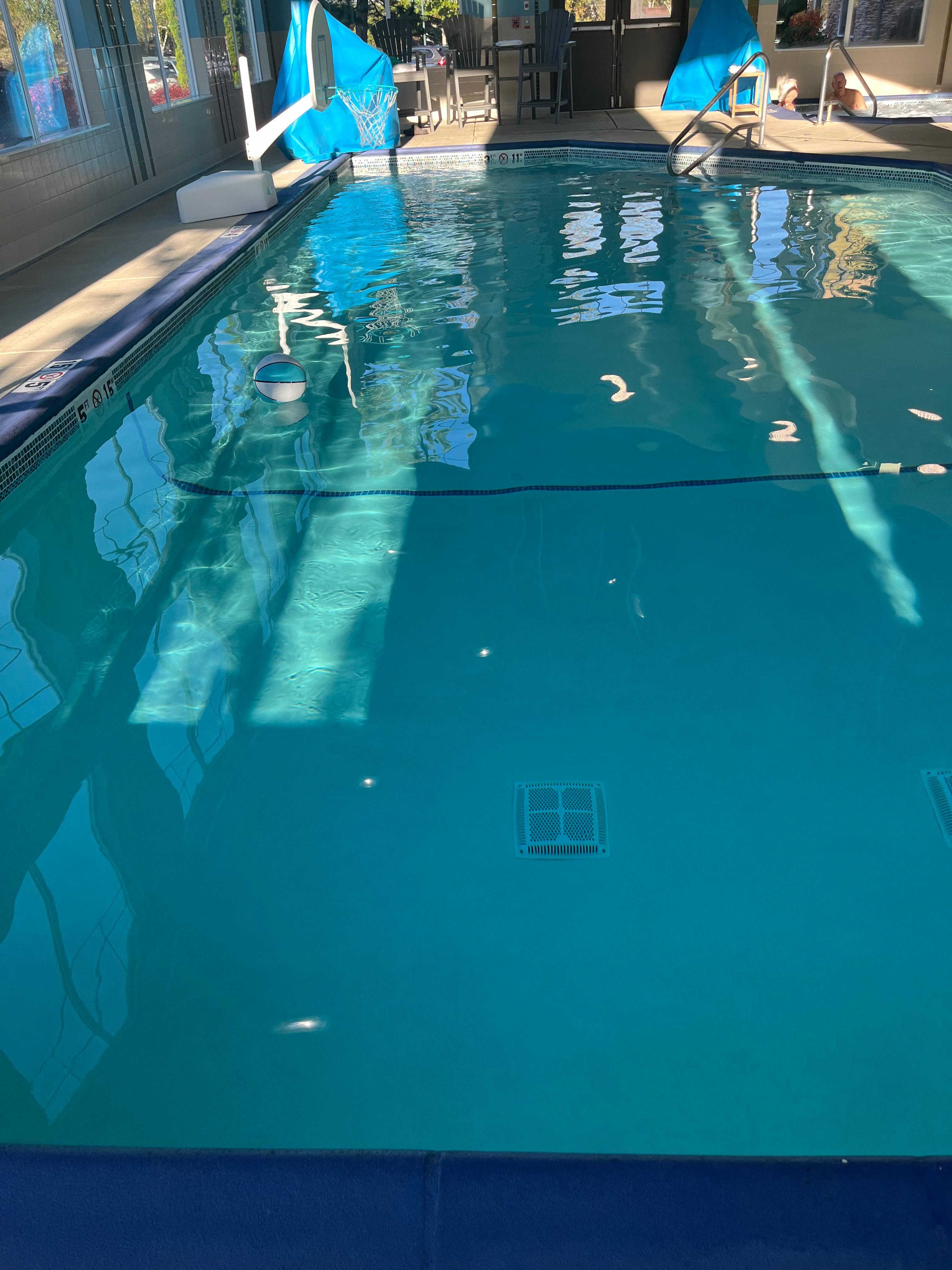 Indoor pool with basketball hoop. Hot tub as well. 