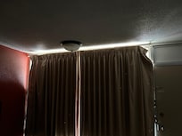 Taped draperies courtesy of me. The pins were missing and the drapes hung open on each end.