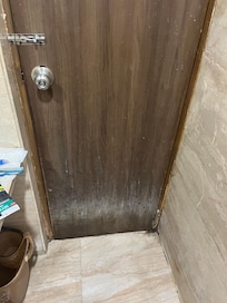 Broken old toilet door with fungus