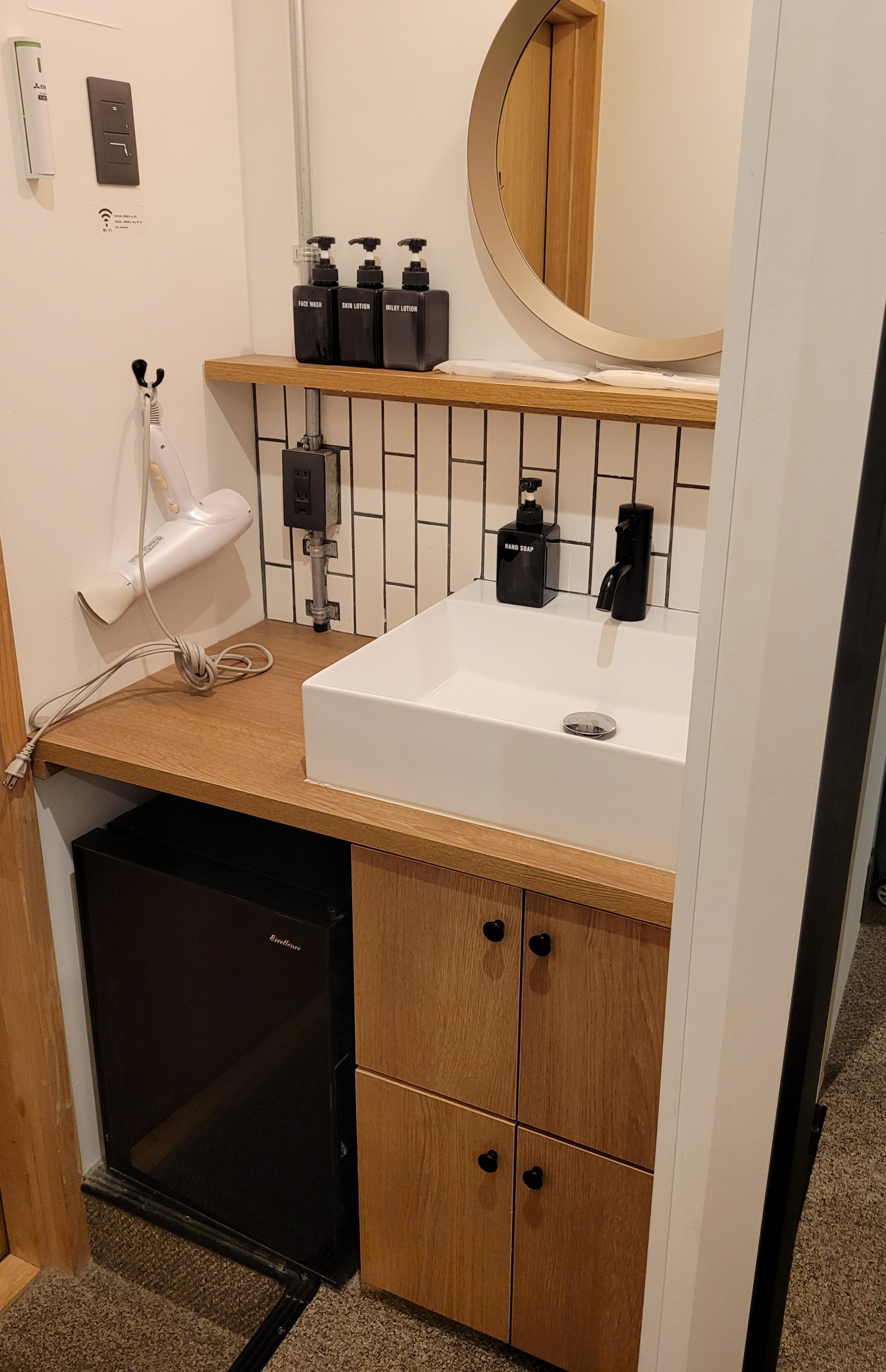 Small sink and fridge area at entry