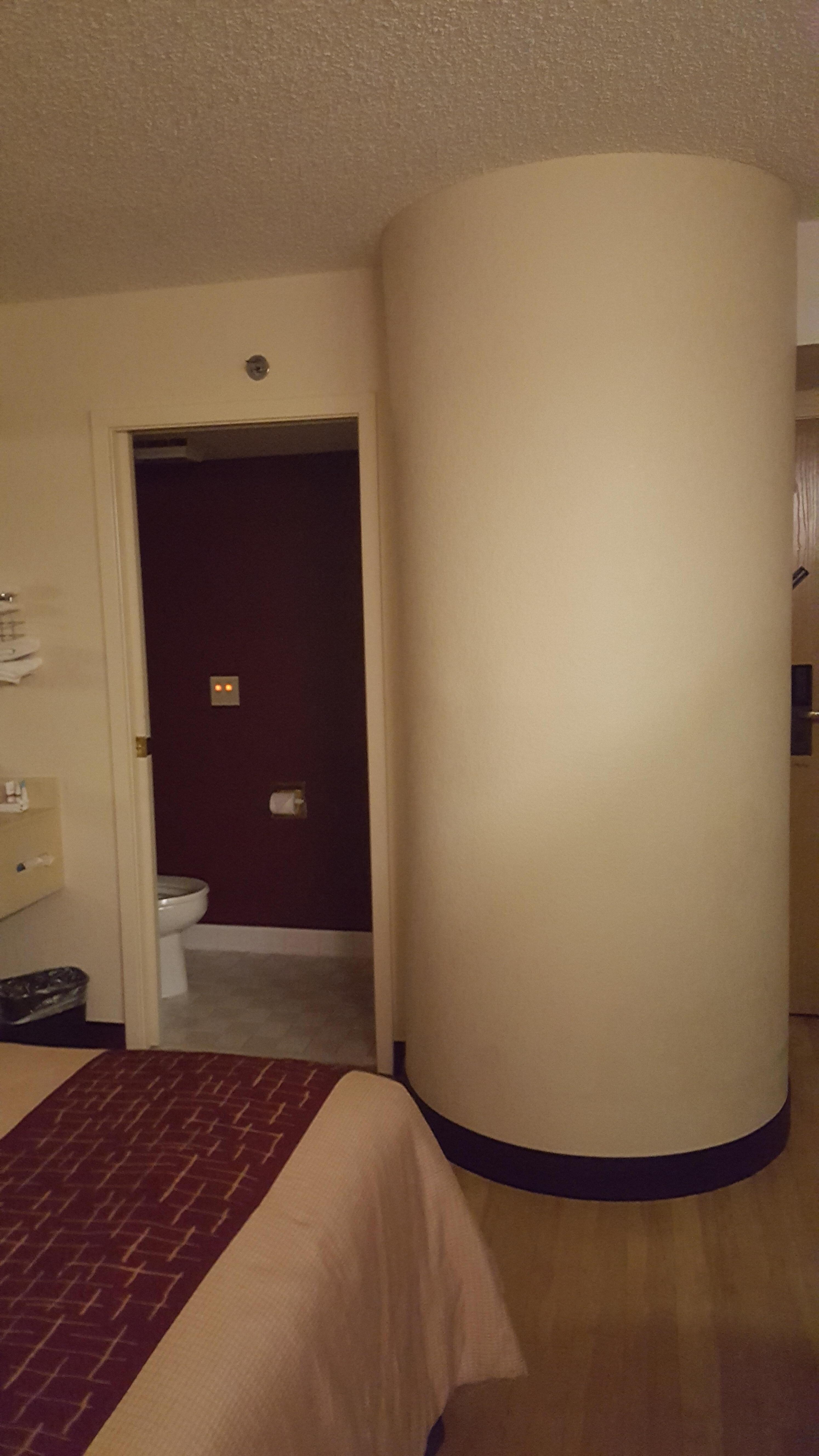 Sink near beds, toilet and shower, no tub