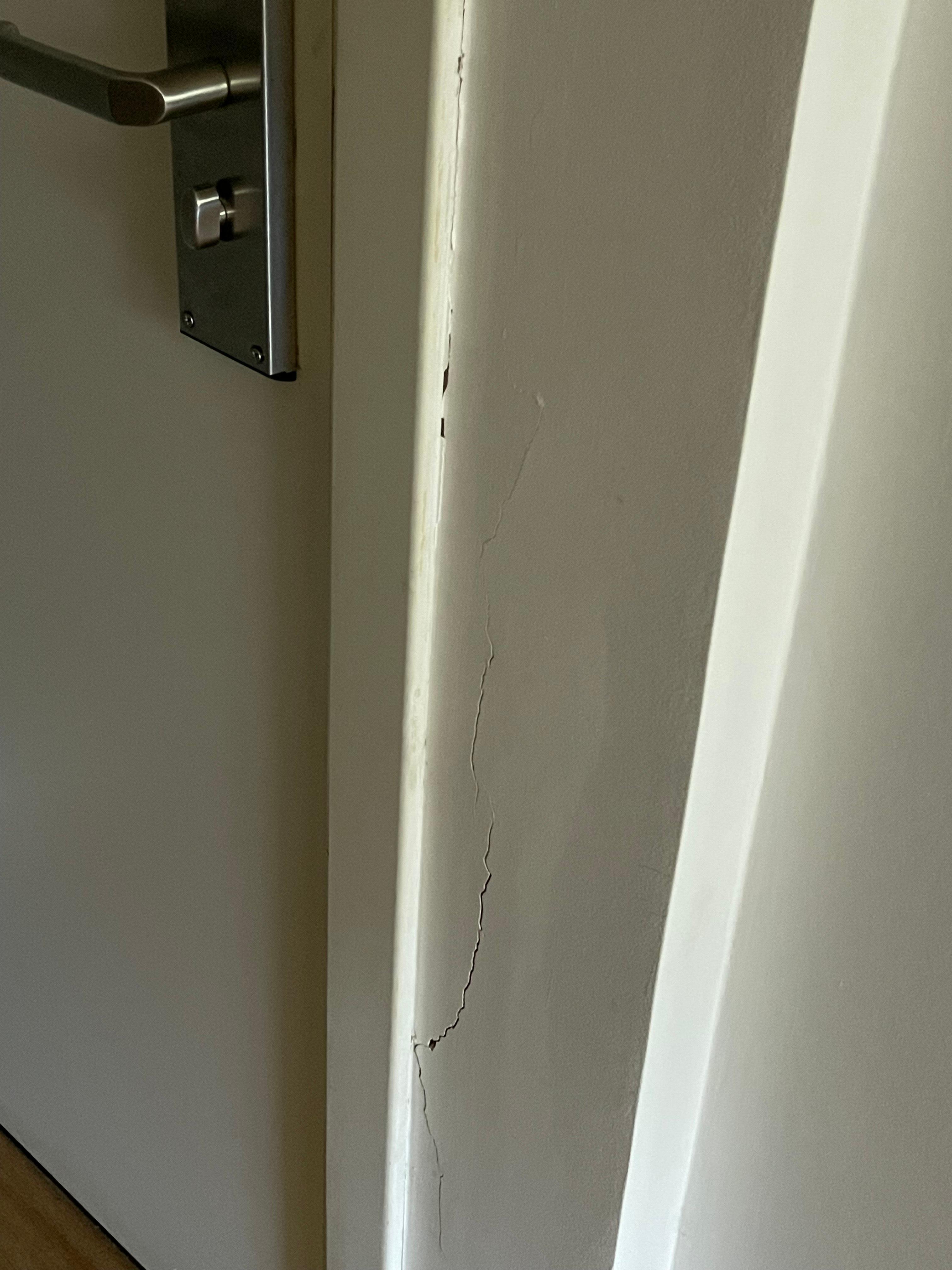 cracked door frames from what looks like attempted break in at one point