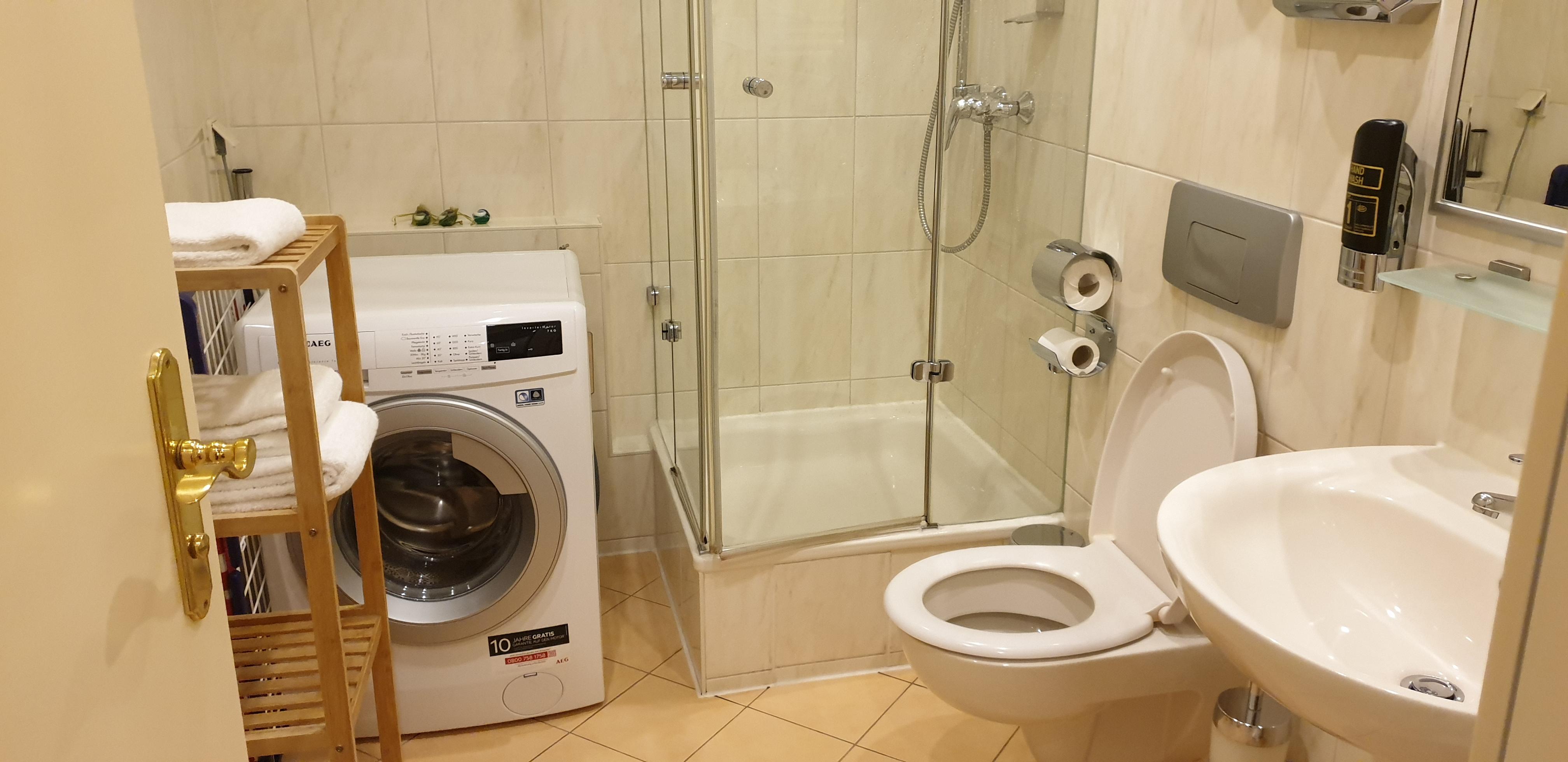 Bathroom with washing machine. Has heated towel rail, handy to dry clothes.