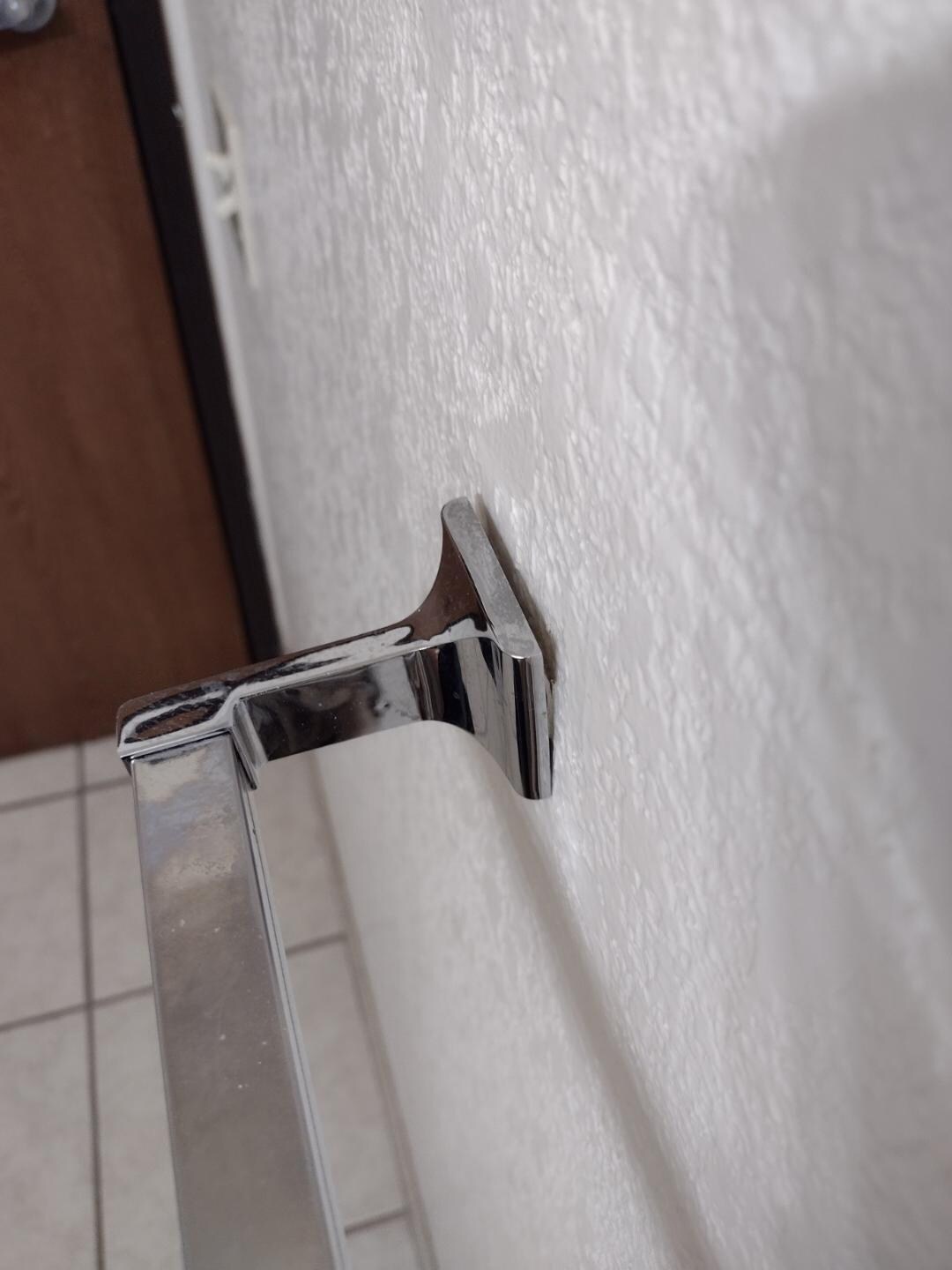 detail of toilet towel bar coming out from wall mount - dangerous!