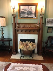1800's fireplace with beautiful columns antique lady lamps on top.