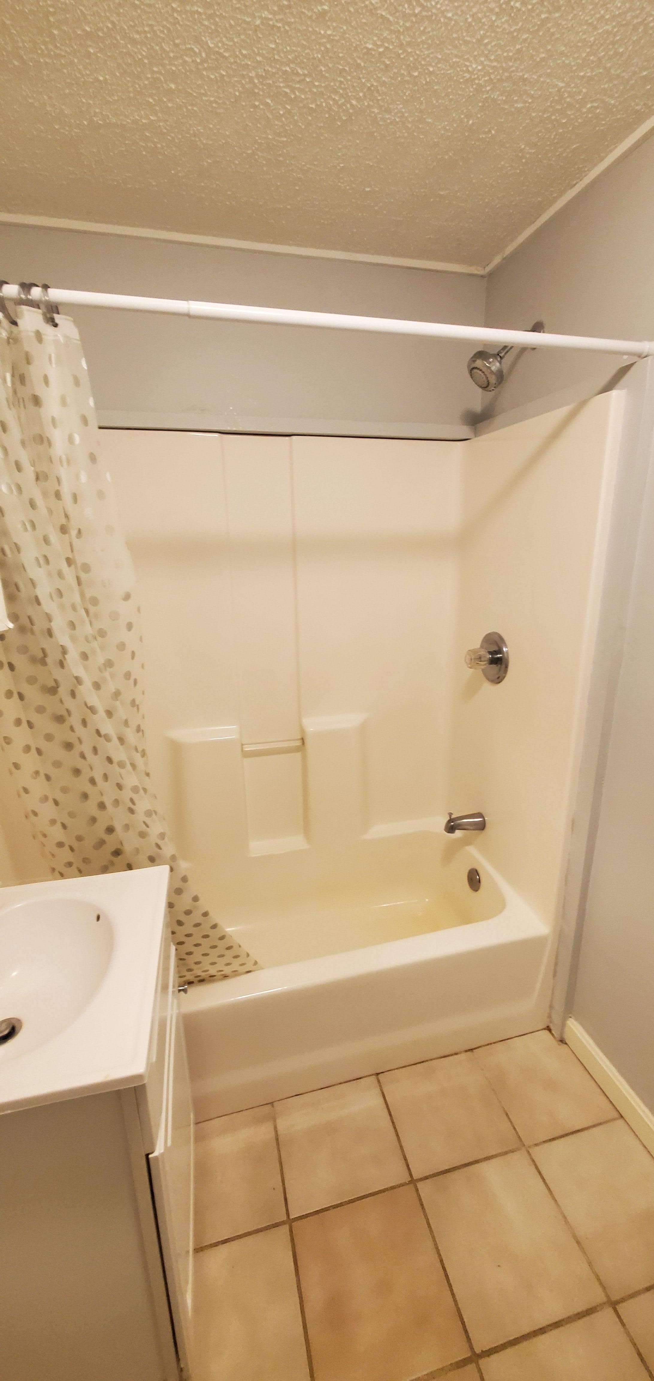 Photo of bathroom with its tiny sink, just to show the shower curtain is indeed in this bathroom