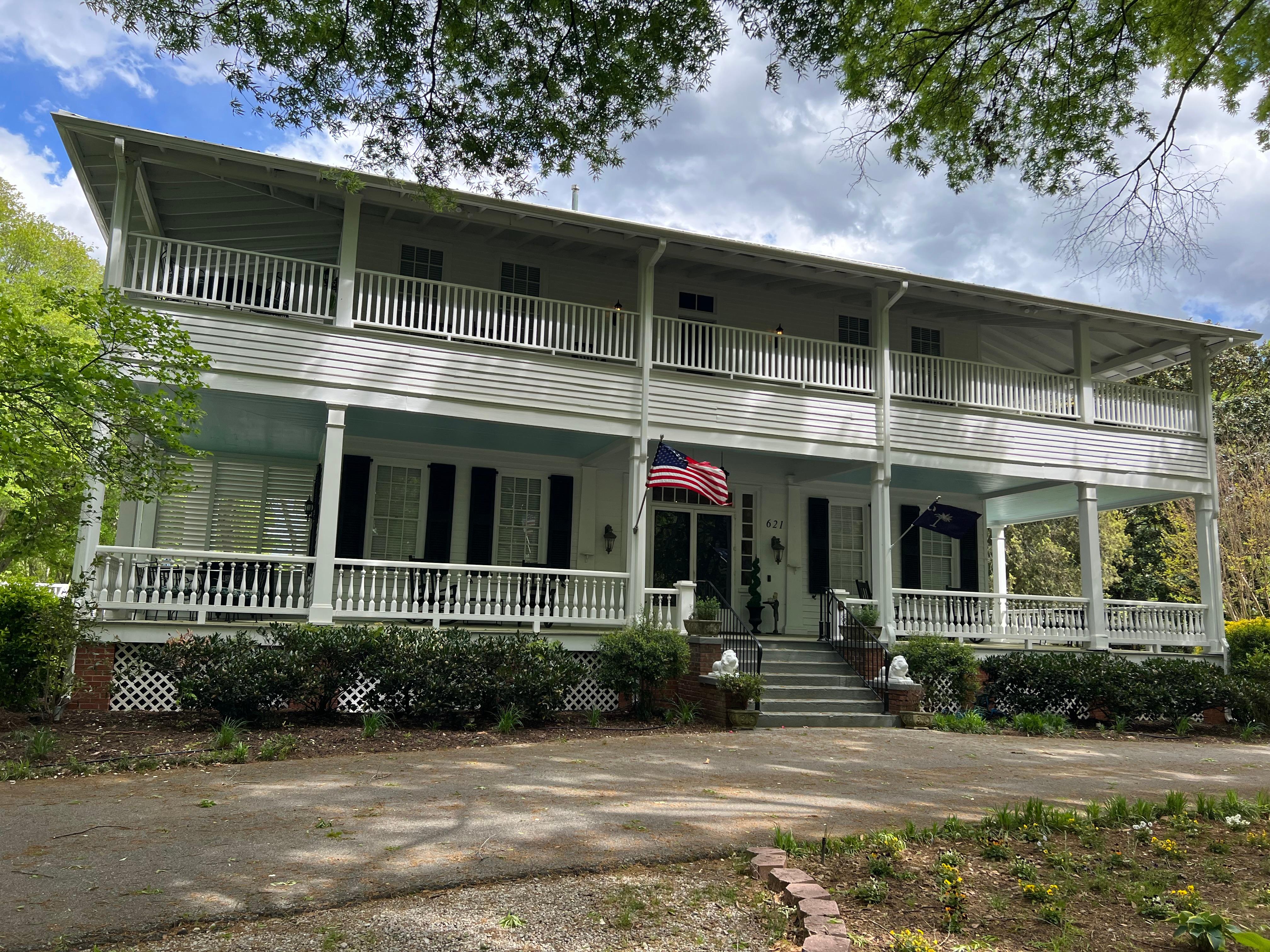 Wrap-around porches upstairs and down with places to sit a spell 