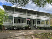 Wrap-around porches upstairs and down with places to sit a spell