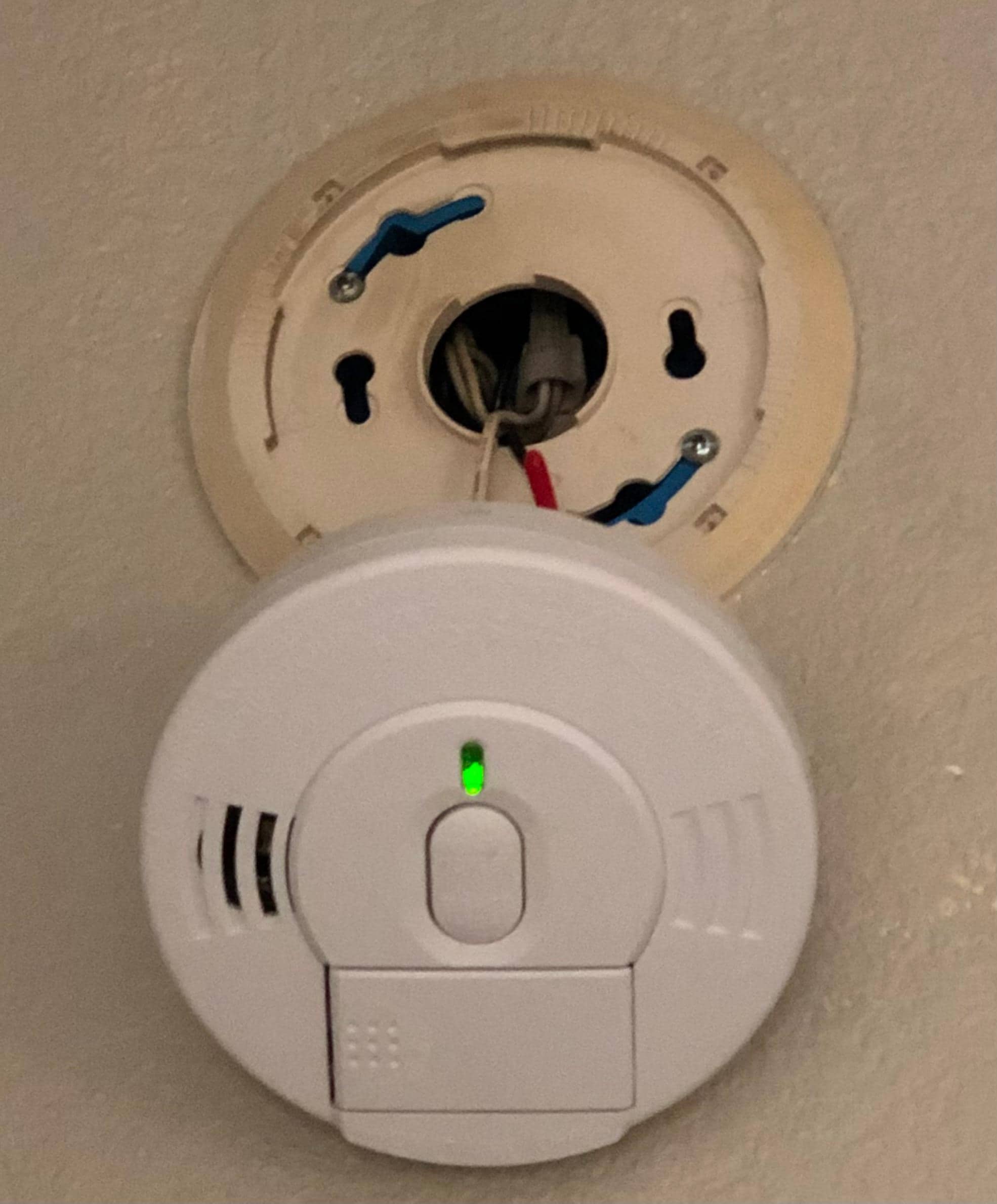 Smoke alarm was hanging off the wall