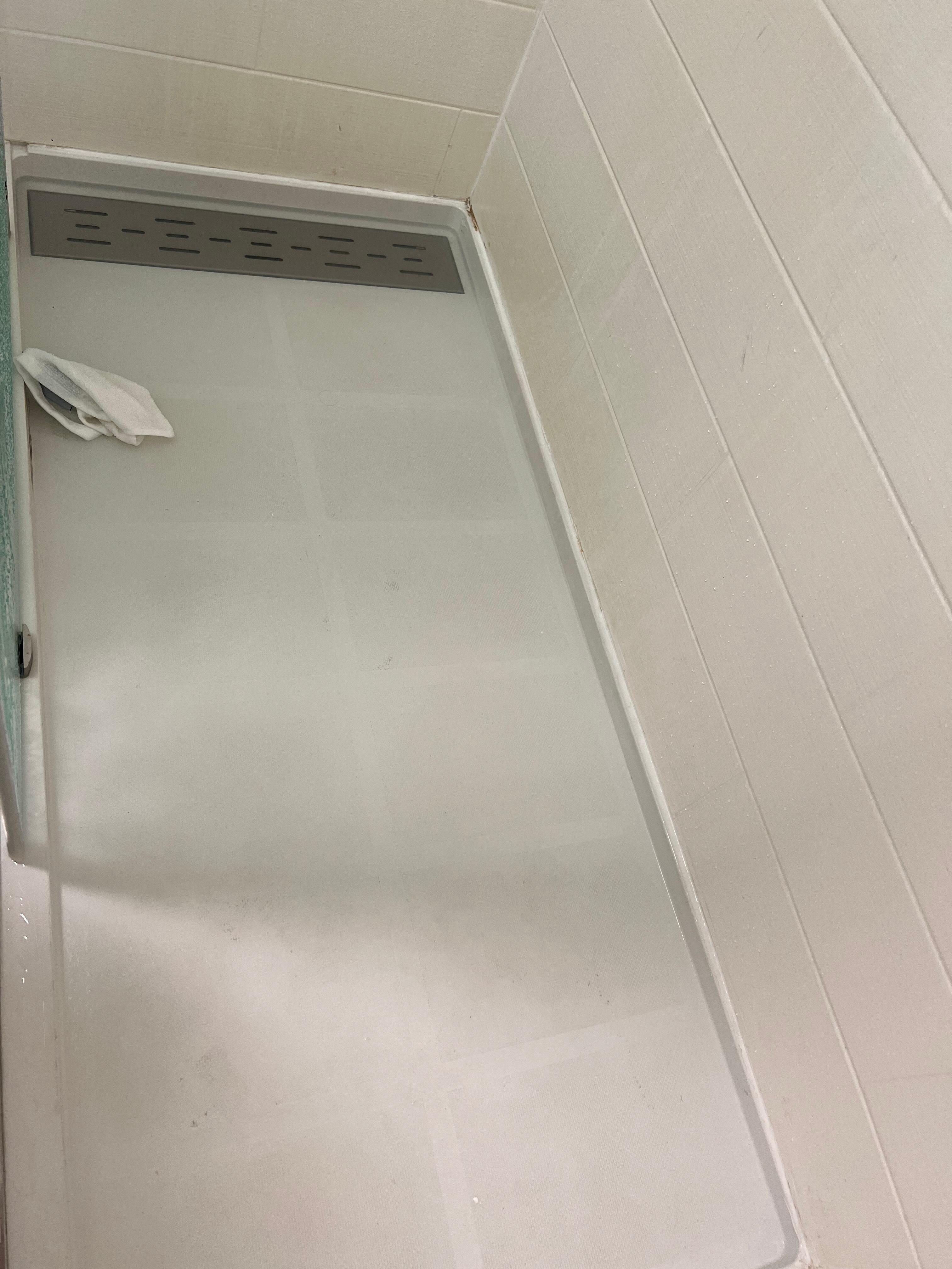 Hard to tell but the floor is flooded and under the metal was so much junk and hair blocking the drain